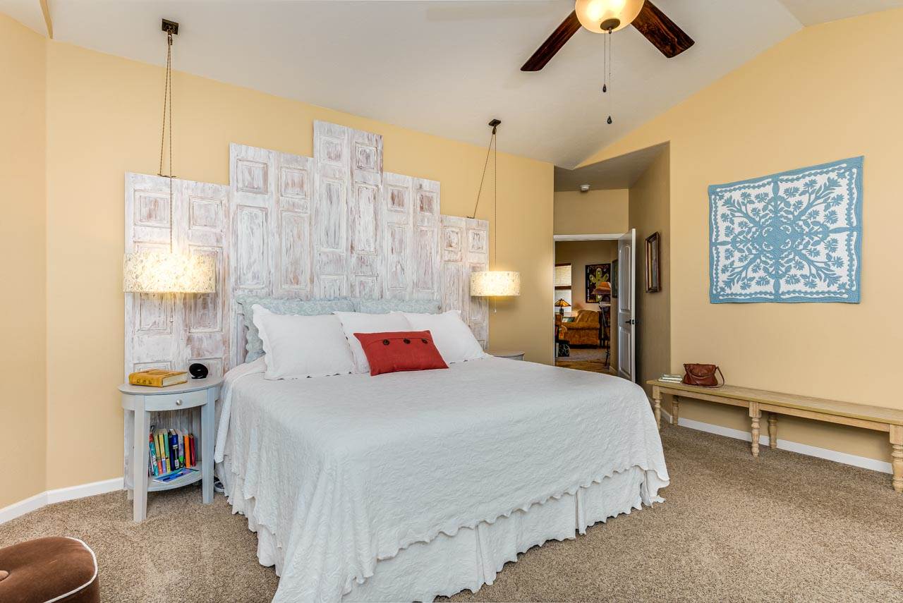 2530 Riata Ranch Court Grand Junction, CO 81505 - Photo 20 of 41 a bedroom with a bed and a chandelier