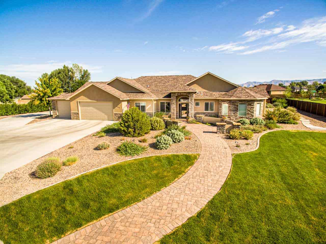 2530 Riata Ranch Court Grand Junction, CO 81505 - Photo 2 of 41 a view of a house with a big yard and large trees