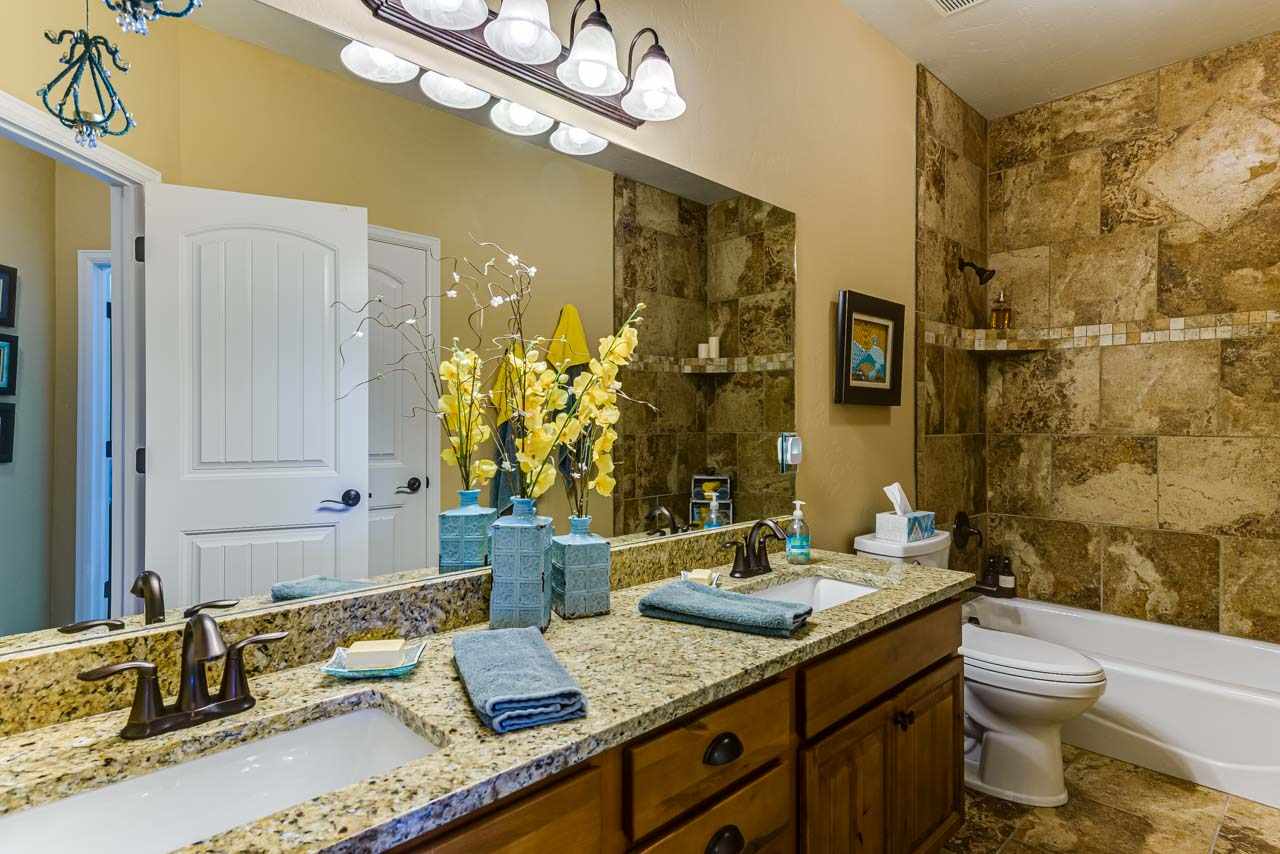 2530 Riata Ranch Court Grand Junction, CO 81505 - Photo 25 of 41 a bathroom with a granite countertop sink and a mirror