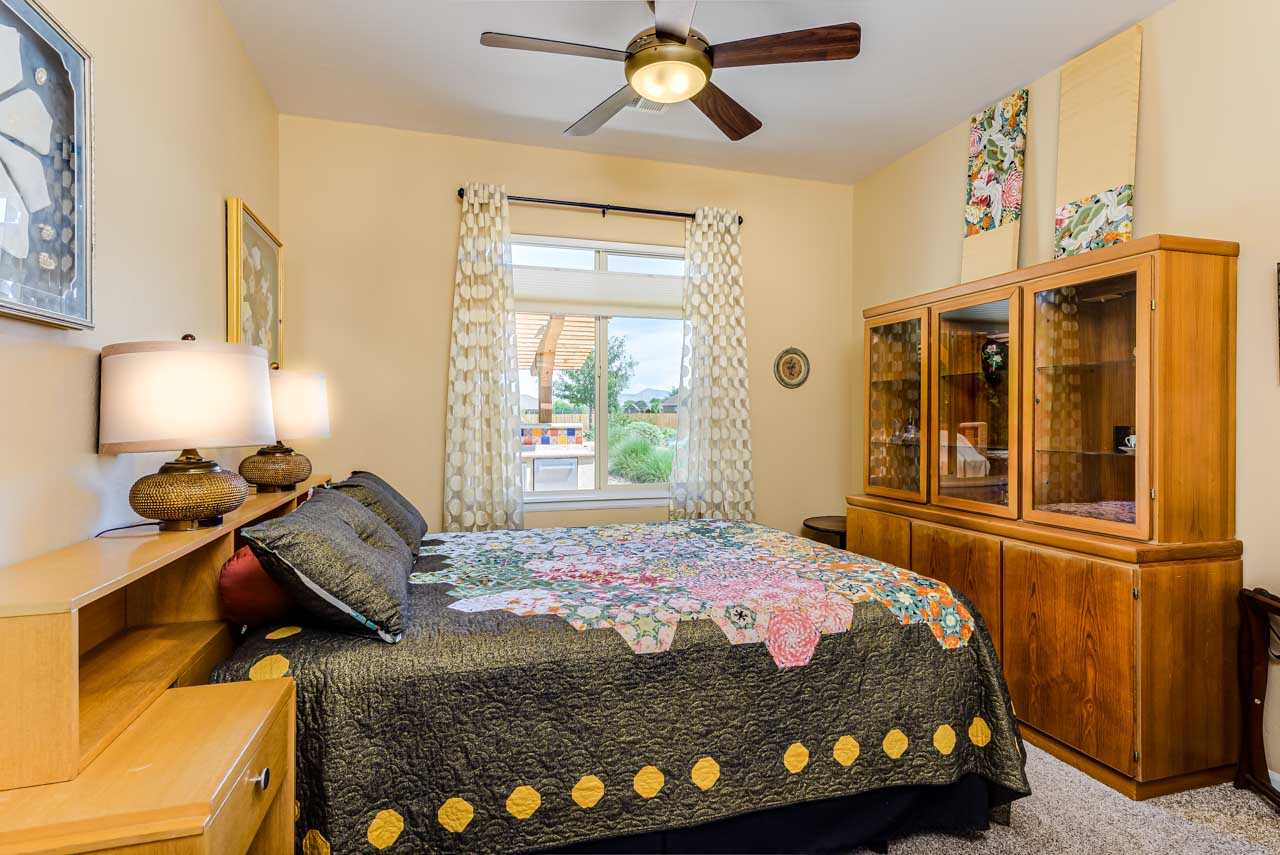 2530 Riata Ranch Court Grand Junction, CO 81505 - Photo 26 of 41 a bedroom with a bed and wooden floor