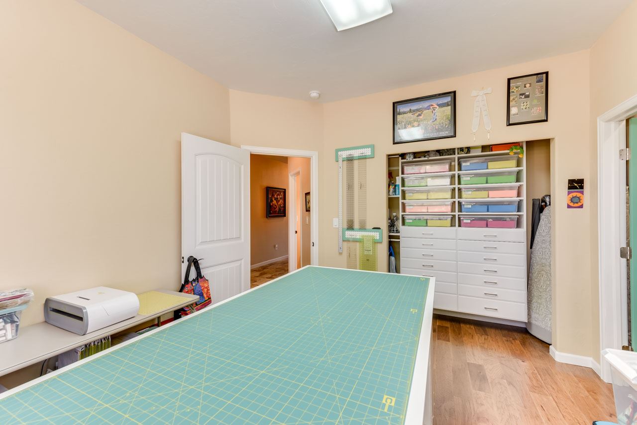 2530 Riata Ranch Court Grand Junction, CO 81505 - Photo 28 of 41 a bedroom with a bed and a wooden floor