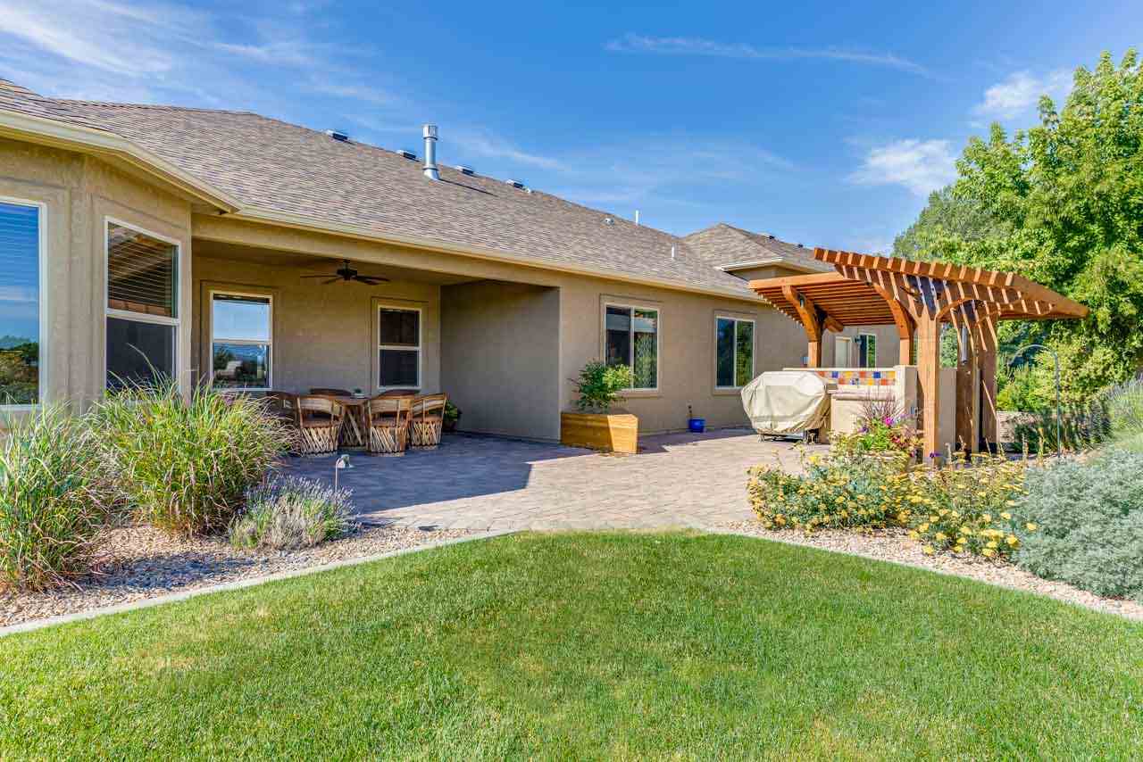 2530 Riata Ranch Court Grand Junction, CO 81505 - Photo 31 of 41 a front view of a house with a garden and plants