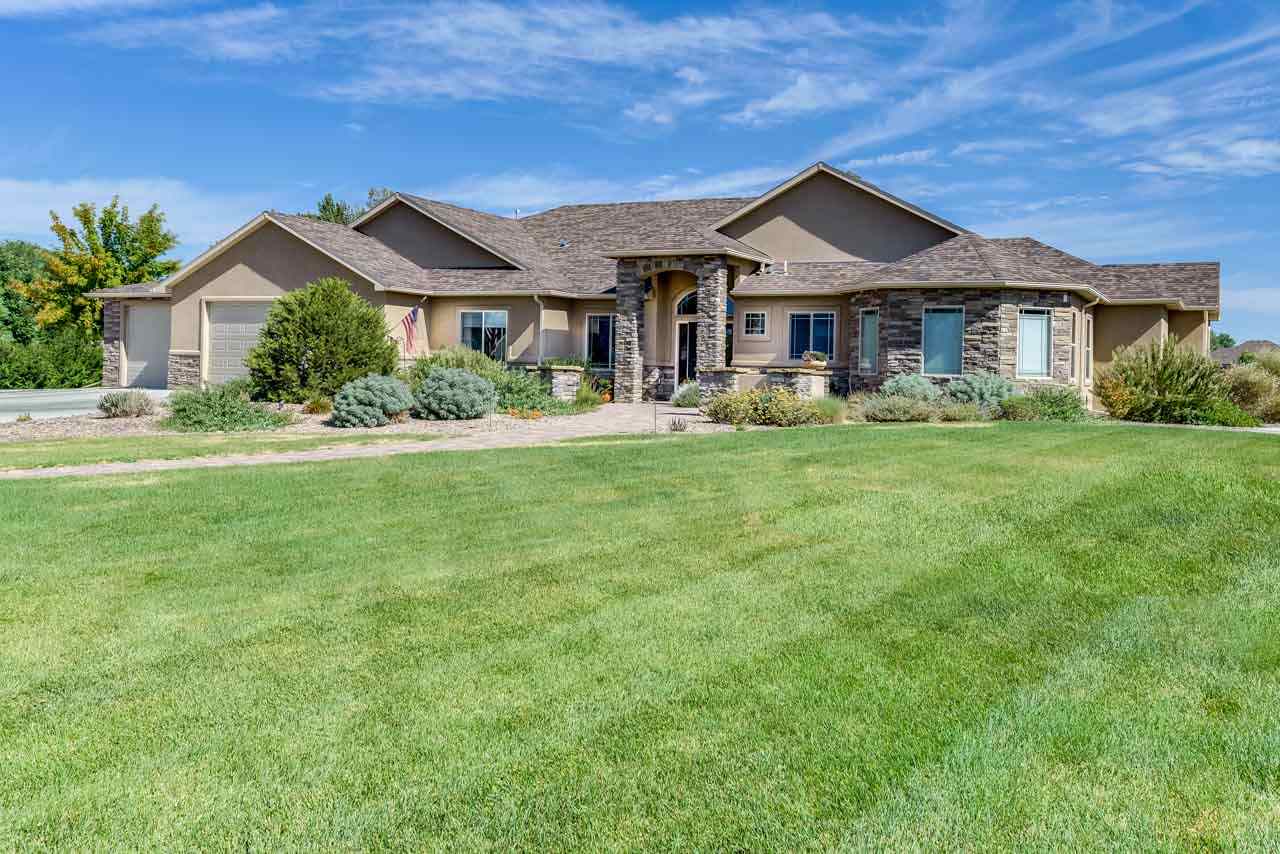 2530 Riata Ranch Court Grand Junction, CO 81505 - Photo 37 of 41 a front view of a house with a garden