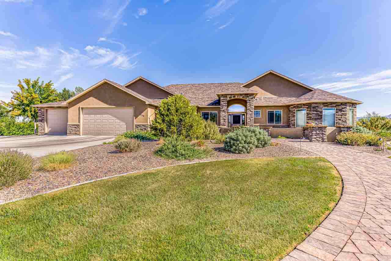 2530 Riata Ranch Court Grand Junction, CO 81505 - Photo 38 of 41 a front view of a house with yard and green space