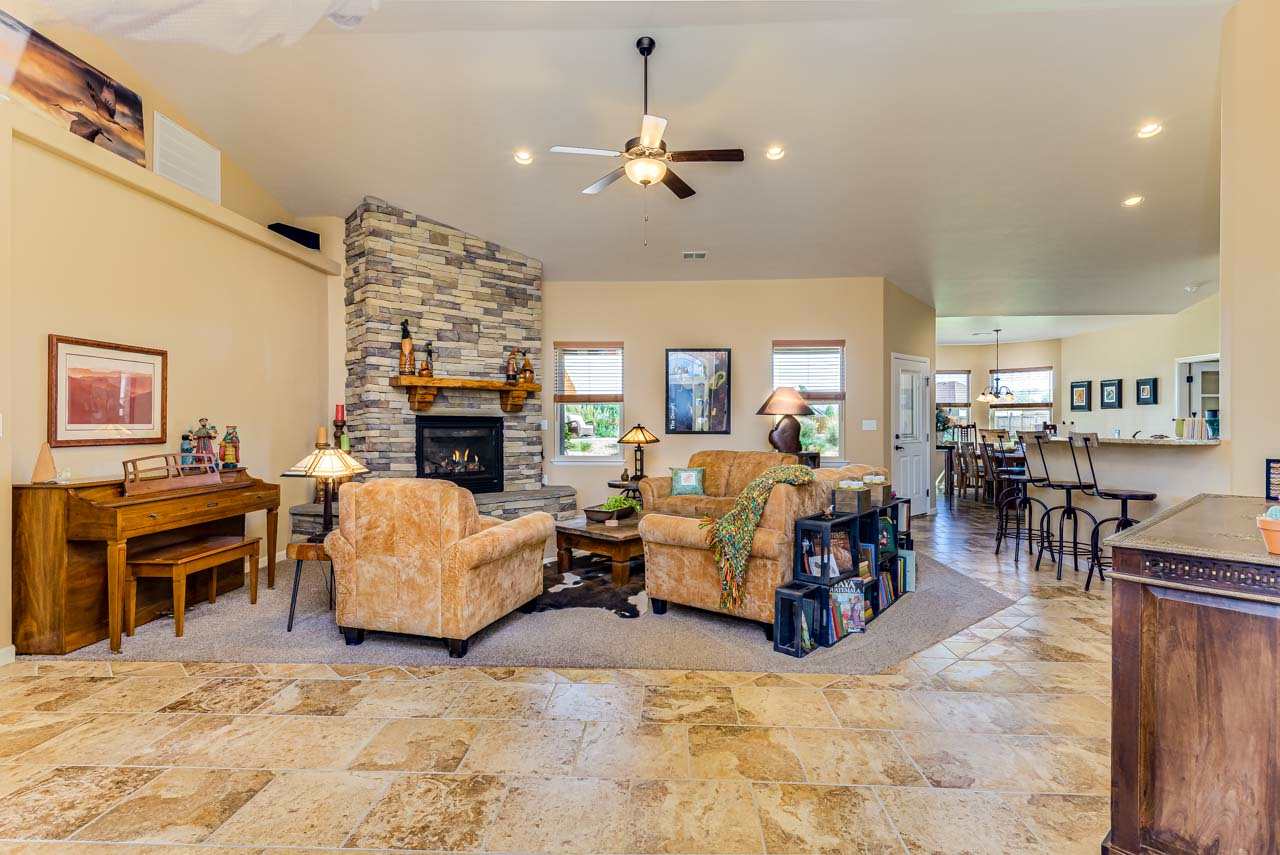 2530 Riata Ranch Court Grand Junction, CO 81505 - Photo 6 of 41 a living room with furniture large window and a fireplace