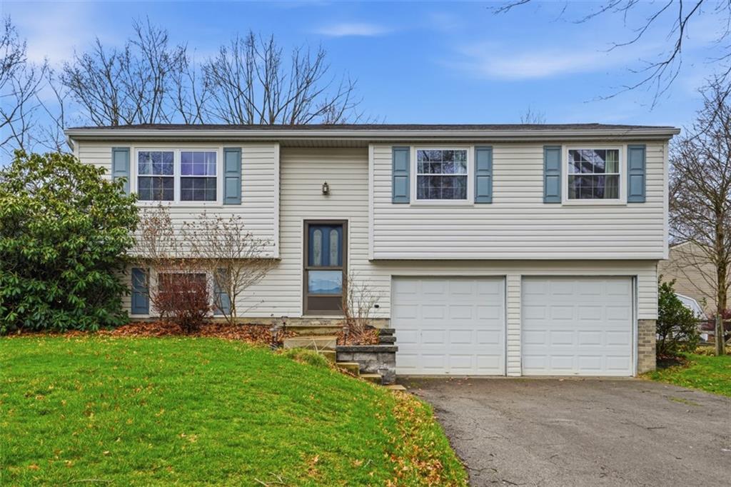 106 Squirrel Hollow Road Gibsonia, PA 15044 - Photo 1 of 46 a house view with a garden space