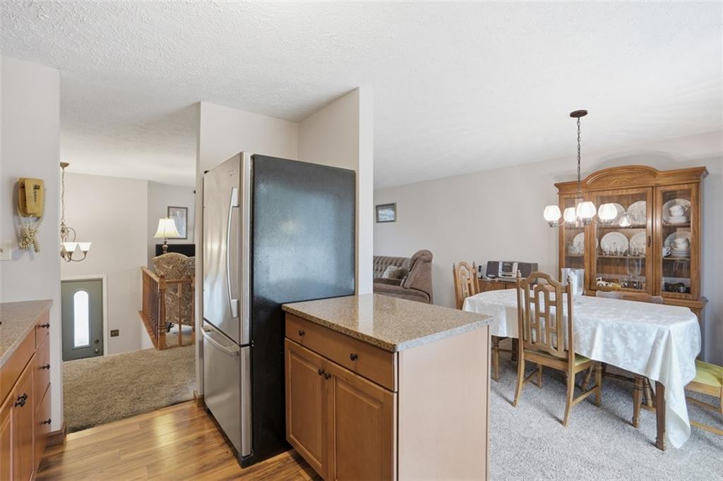 106 Squirrel Hollow Road Gibsonia, PA 15044 - Photo 15 of 46 a kitchen with a refrigerator a sink and chairs