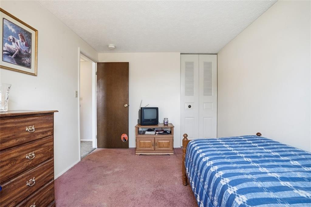 106 Squirrel Hollow Road Gibsonia, PA 15044 - Photo 28 of 46 a bedroom with a bed and wooden floor
