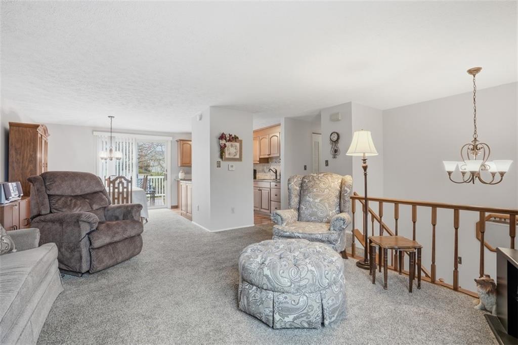 106 Squirrel Hollow Road Gibsonia, PA 15044 - Photo 8 of 46 a living room with furniture and a dining table