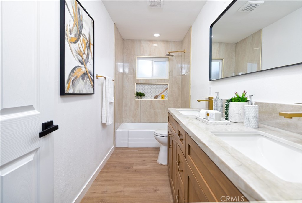 3306 Debbie Lane Riverside, CA 92501 - Photo 15 of 32 a bathroom with a sink and mirror with shower
