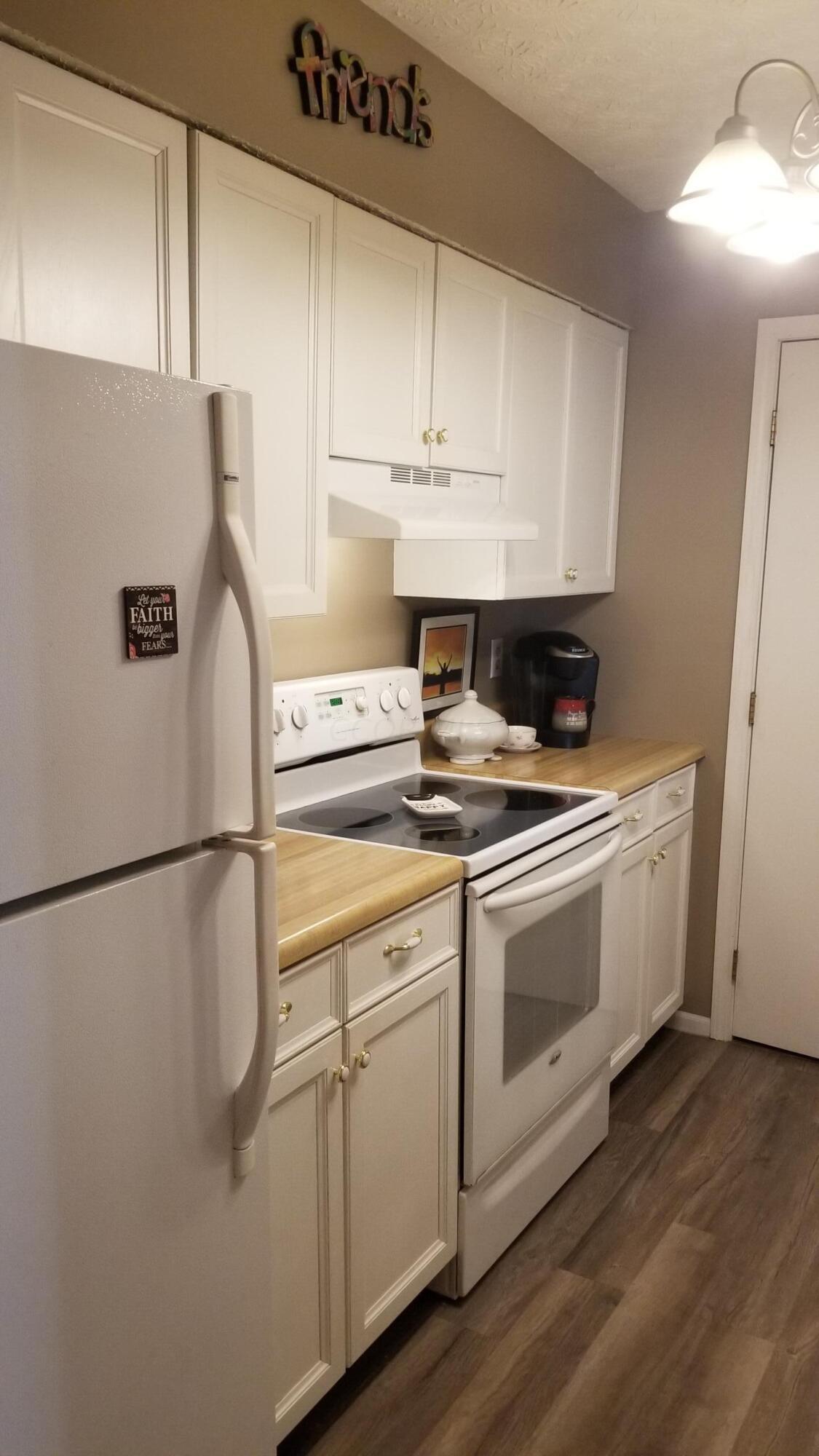 3939 Karl Road, Unit 111 Columbus, OH 43224 - Photo 7 of 22 Kitchen with laminate wood flooring, opening to livingroom and Laundry at back of Kitchen