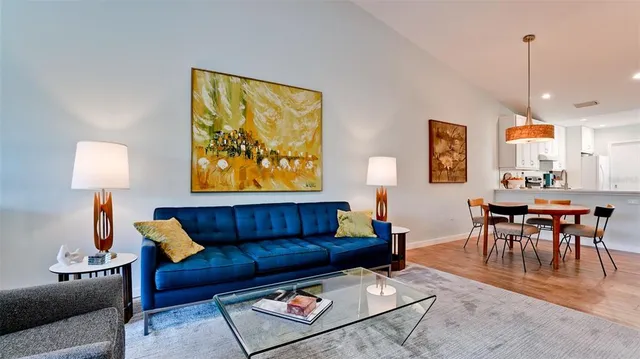 a living room with furniture and a lamp
