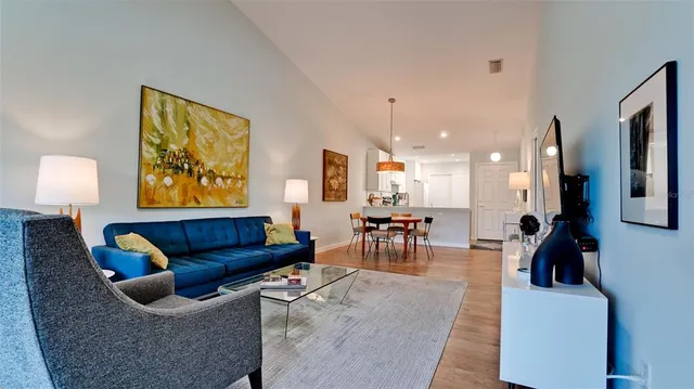a living room with furniture and a lamp