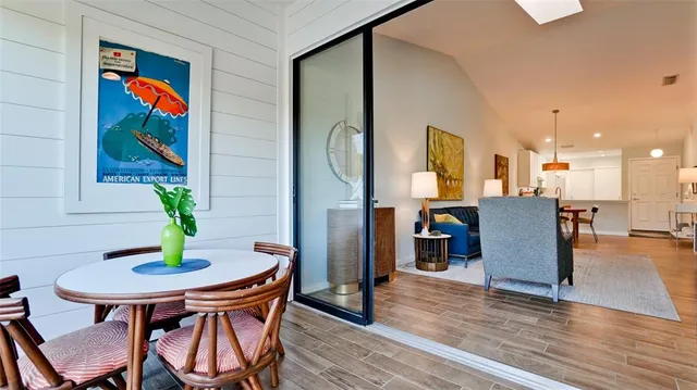 a view of a dining room with furniture and wooden floor