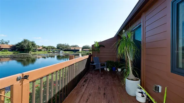 a view of swimming pool with outdoor seating and plants