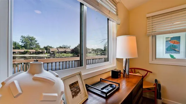 a living room with furniture fireplace and a large window