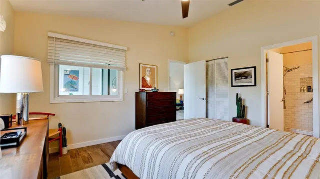 a bedroom with a bed and a lamp on table