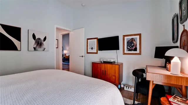 a bedroom with a bed and a flat screen tv