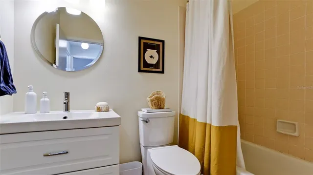 a bathroom with a sink mirror vanity and toilet