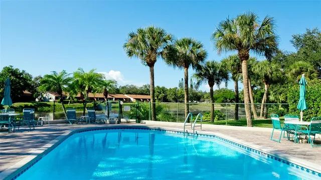 a view of a swimming pool with a table and chairs