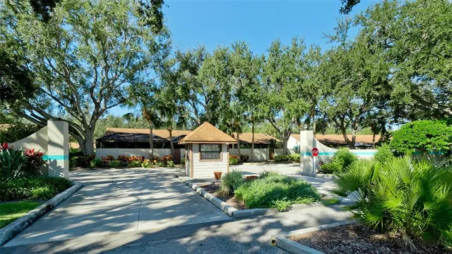 a view of a town with sitting area and large trees