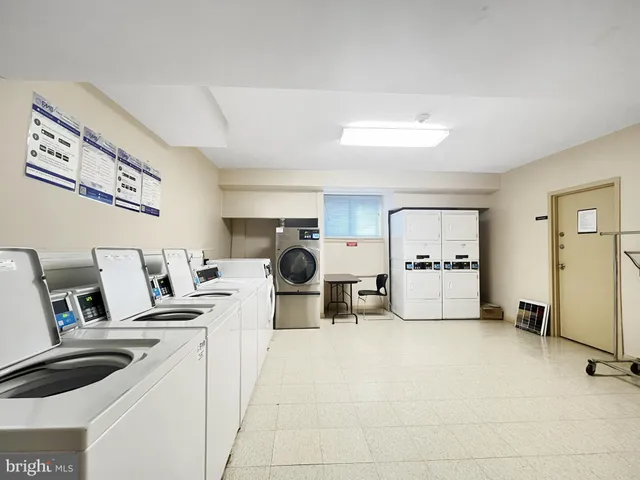 a living room with lots of furniture and kitchen view