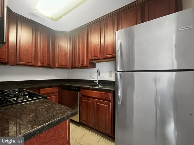 a kitchen with a sink and a refrigerator