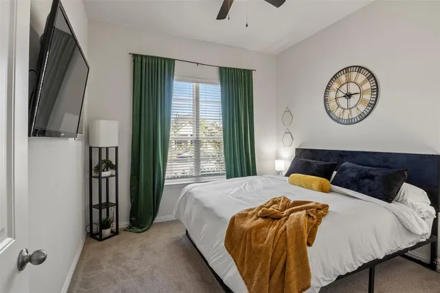 a bedroom with a bed and flat screen tv