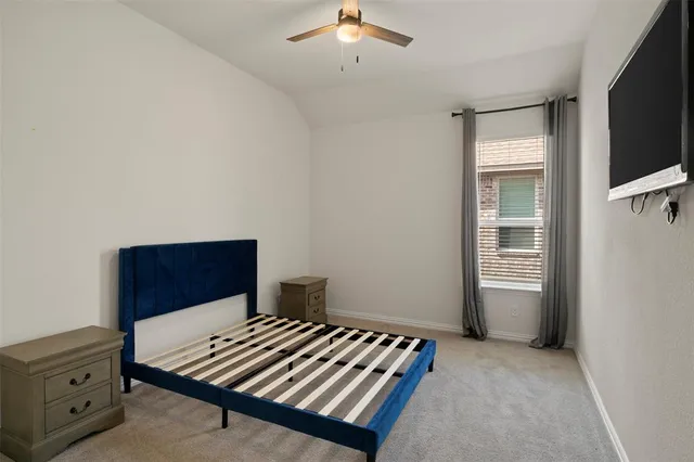 a bedroom with bed and a window