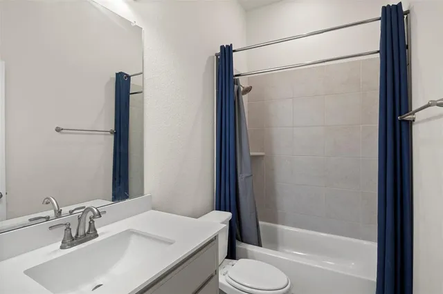 a living room with a bed furniture and a large window