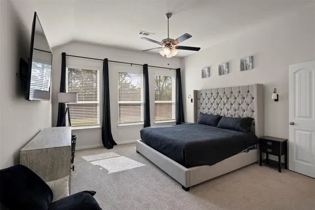 a bedroom with a bed and a flat screen tv