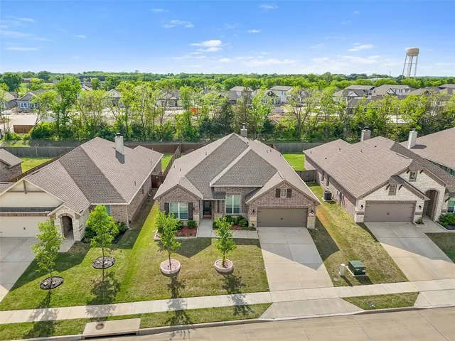 an aerial view of multiple houses with a yard