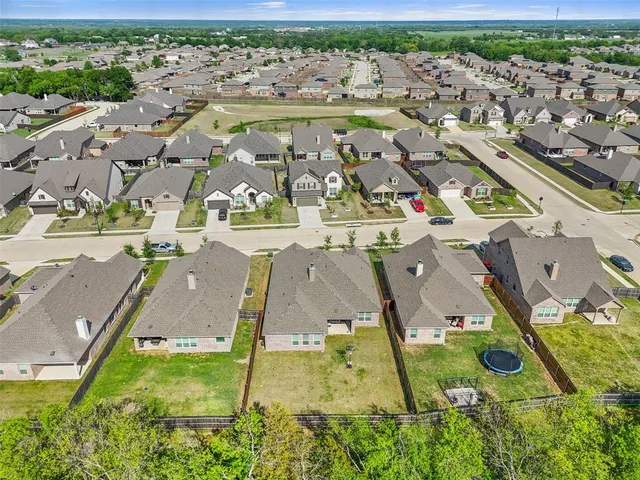 an aerial view of residential houses with outdoor space