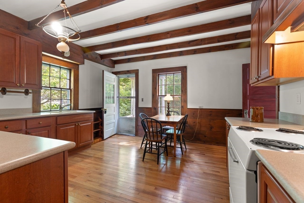 17 Pine Road Sharon, MA 02067 - Photo 15 of 33 a kitchen with a table chairs and wooden floor