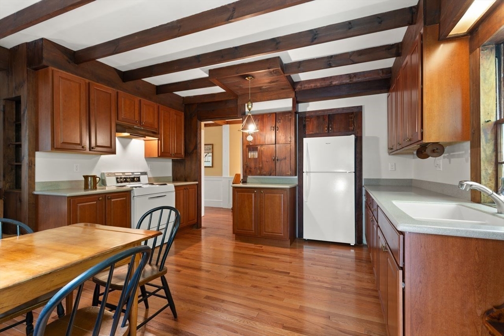 17 Pine Road Sharon, MA 02067 - Photo 16 of 33 a kitchen with a table chairs refrigerator and a sink
