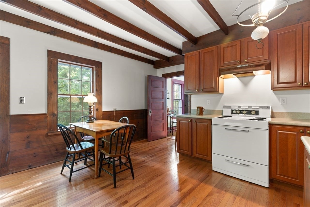 17 Pine Road Sharon, MA 02067 - Photo 17 of 33 a kitchen with a table chairs and wooden floors