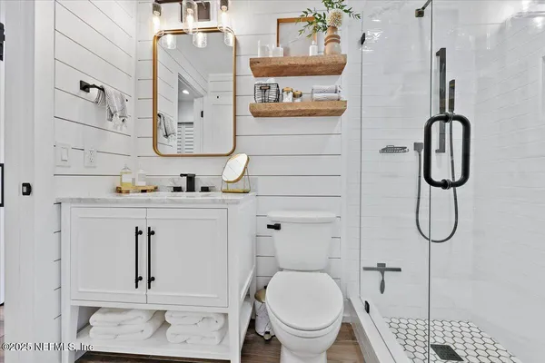 a bathroom with a toilet sink and shower