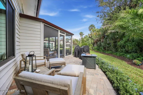 a view of a patio with couches chairs and potted plants