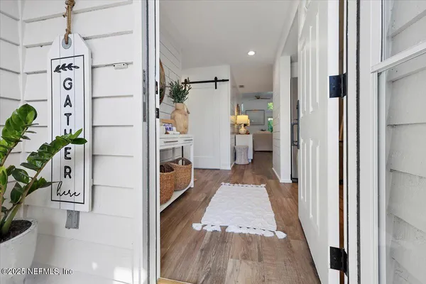 a hallway with a white stove top oven and a rug