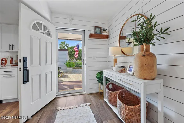 a bathroom with a sink a mirror and a potted plant