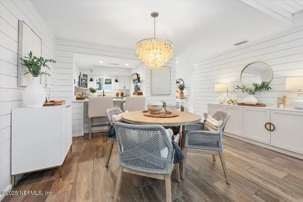 a view of a dining room with furniture and chandelier
