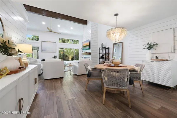 a view of a dining room with furniture window and wooden floor