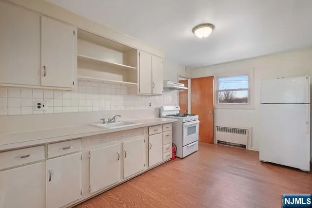 a kitchen with sink cabinets and window