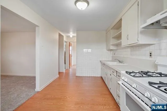 a kitchen with stainless steel appliances granite countertop a stove and a sink