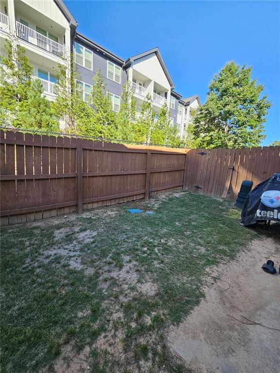 5747 Radford Loop Fairburn, GA 30213 - Photo 31 of 36 a view of a backyard with potted plants and wooden fence