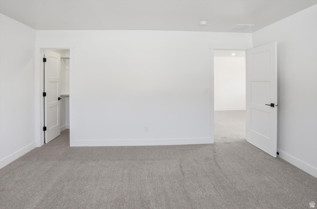 1315 West 3200 South, Unit 17 Perry, UT 84302 - Photo 38 of 58 Spacious room featuring light gray carpeting, crisp white walls, and contemporary three-panel doors with matte black hardware