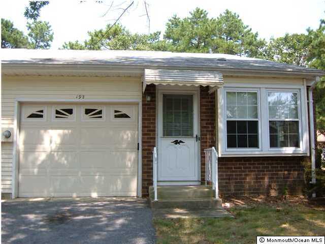 19A Sunset Road, Unit B Whiting, NJ 08759 - Photo 1 of 3 a front view of a house with a yard