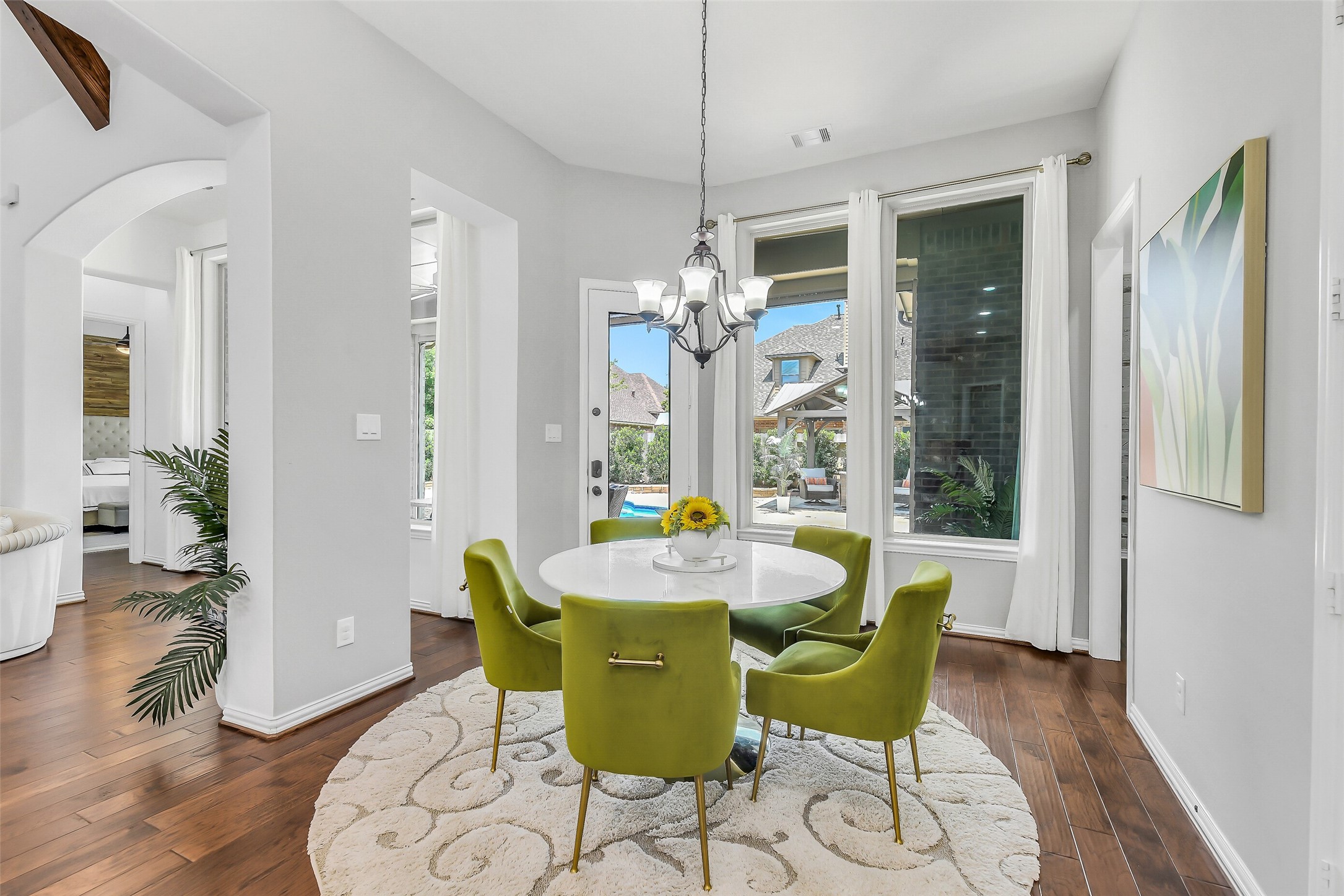 12207 Shorebridge Road Cypress, TX 77433 - Photo 16 of 41 a dining room with furniture a chandelier and wooden floor