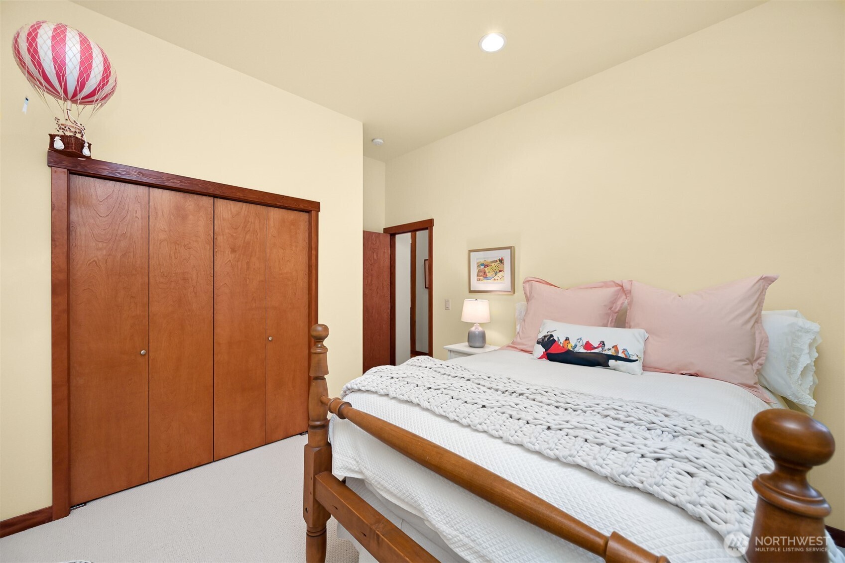 1910 40th Street Bellingham, WA 98229 - Photo 29 of 40 a bedroom with a bed and a chandelier