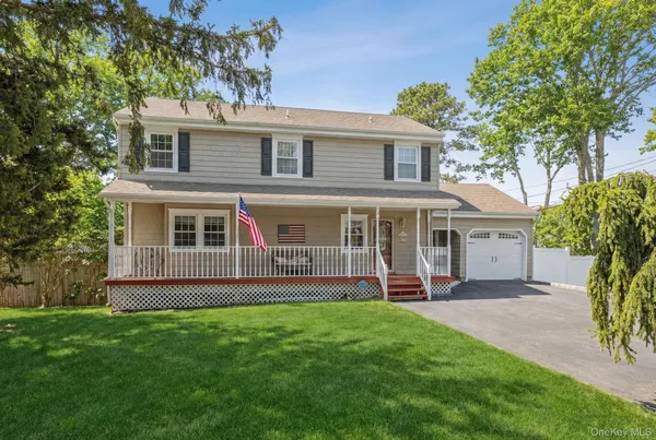 a front view of a house with a yard and porch